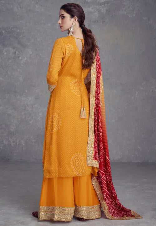 Exclusive Yellow Chinon Silk Embroidered Suit with Mirror Work and Bandhani Dupatta